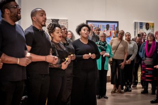 Gospel choir sings at the reception for ransome's "Up South" exhibition